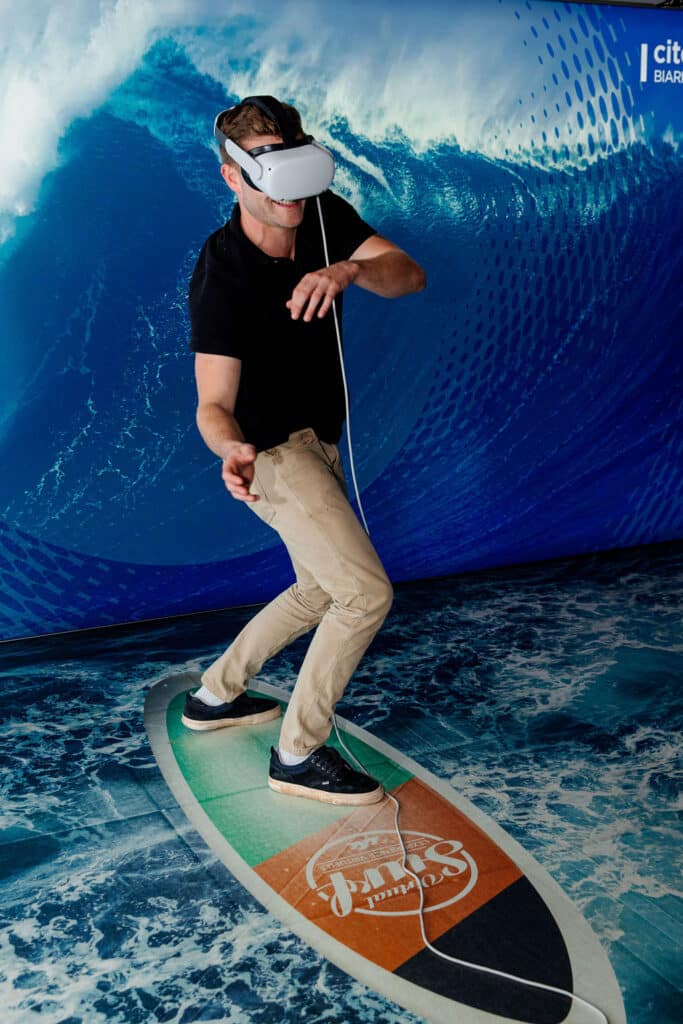 Participant with a VR headset for an immersive surfing experience